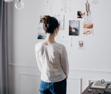 Girl looking pictures on the wall